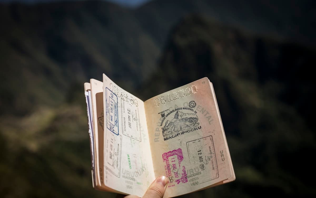 Open passport on a mountain background